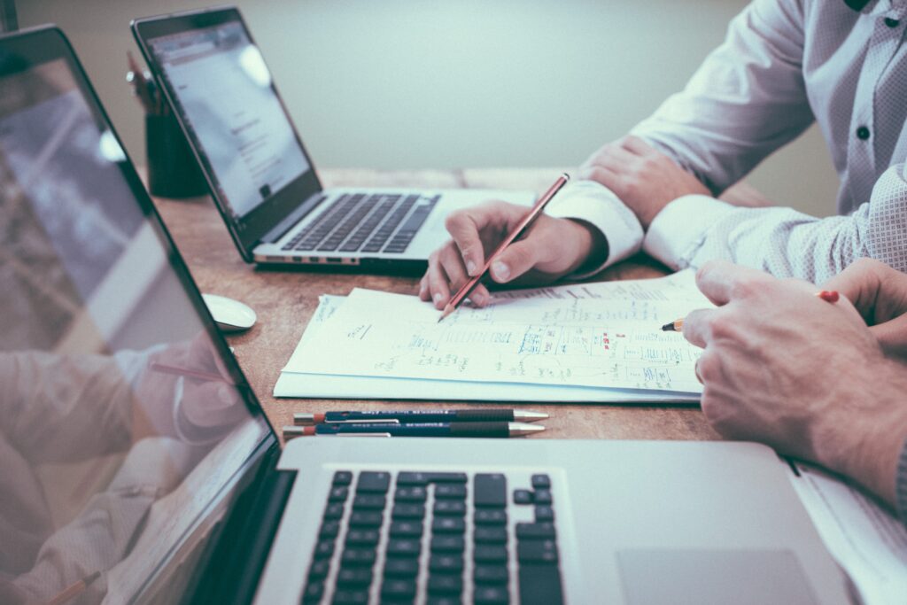 laptop, tablet, and pen as tools used by Coto de Caza real estate companies to create a marketing plan