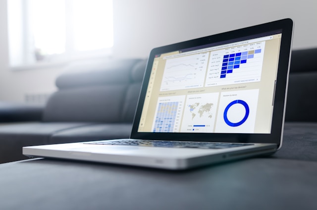 laptop with charts showing financial information